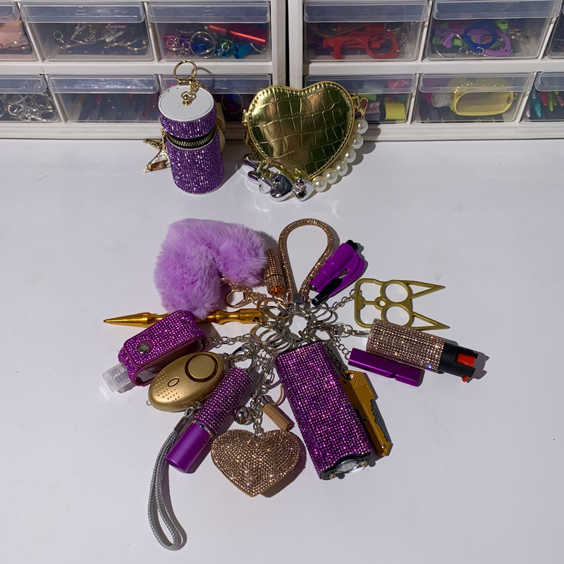 Purple And Gold Shiny Lightning Keychain 16pcs Keychain Set - Premium self defense keychain set for women's personal safety. Features 16-piece comprehensive set and Multiple defense tools.